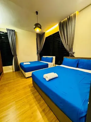 two beds in a room with blue sheets at Private Pool Villa Near Batu Ferringhi Beach in Batu Ferringhi