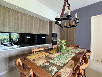 a dining room with a wooden table and chairs at By The Sea Batu Ferringhi, Penang Beach in Batu Ferringhi