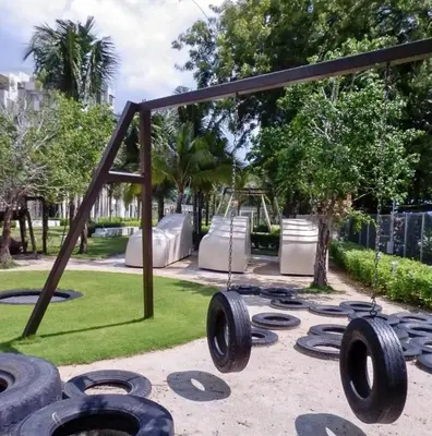 a playground with tire swings in a park at By The Sea Batu Ferringhi, Penang Beach in Batu Ferringhi