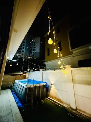 a view of a swimming pool at night at Batu Ferringhi Home Near Beach in Penang with private pool in Batu Ferringhi