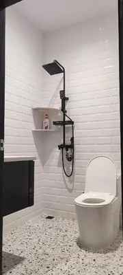 a bathroom with a toilet and a shower at Akasea Sojourn in Gua Sai