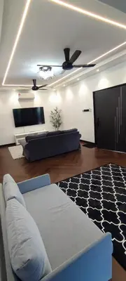a living room with a couch and a flat screen tv at Akasea Sojourn in Gua Sai