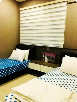 a bedroom with two twin beds and a window at GA Homes Homestay - Majestic Ipoh Condo in Ipoh