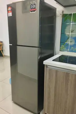 a refrigerator in a kitchen next to a counter at GA Homes Homestay - Majestic Ipoh Condo in Ipoh