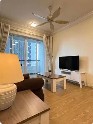 a living room with a couch and a flat screen tv at GA Homes Homestay - Majestic Ipoh Condo in Ipoh