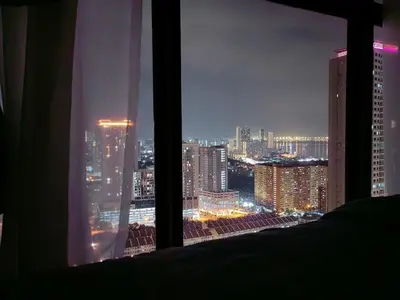a view of a city skyline from a window at Urban Suites Jelutong Georgetown 2BR Leisure City Night View in Jelutong