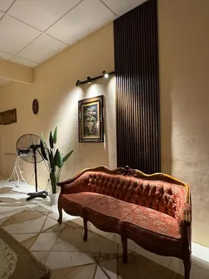 a living room with a couch in a room at Casa de' Sara Pool Homestay Ipoh in Ipoh