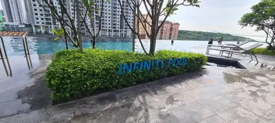 a sign on a bush next to a body of water at Georgetown Penang - Skyline at Urban Suites - Affordable-Luxury-Cozy Stays with Sea and City Views in Jelutong