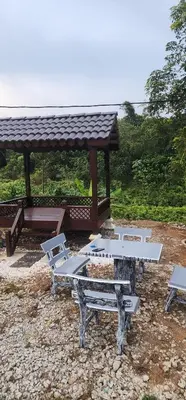 a group of picnic tables and a gazebo at Homestay Ummi Baling in Baling