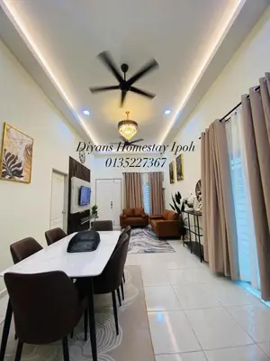 a dining room with a table and chairs and a ceiling at Diyans Homestay Ipoh in Ipoh