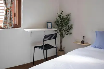 a bedroom with a chair next to a bed at A Cozy Place Penang in George Town