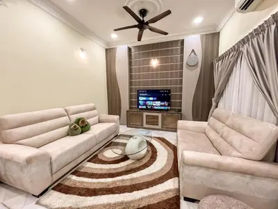 a living room with a couch and a tv at Capybara Kids House 12 Pax 5 min to Ipoh Town in Ipoh