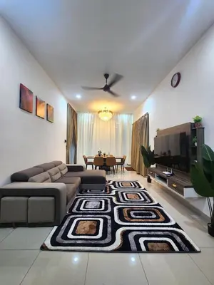 a living room with a couch and a table at Dirgahayu Homestay III Serindit in Kulim