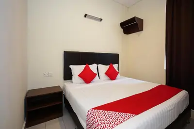 a bedroom with a large bed with red pillows at Dancenter Near Petronas Kampung Koh, Jj Hotel in Kampung Koh