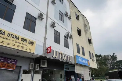 a building with a sign on the side of it at Dancenter Near Petronas Kampung Koh, Jj Hotel in Kampung Koh