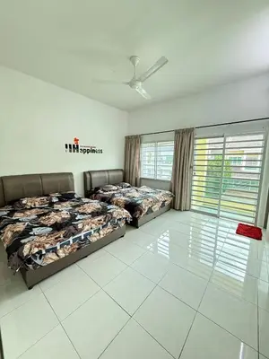 two beds in a large room with windows at AzzaleaHomes 7 Cameron Highlands in Brinchang