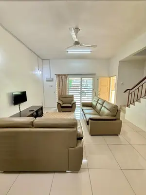 a living room with two couches and a tv at AzzaleaHomes 7 Cameron Highlands in Brinchang