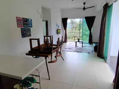 a dining room with a table and chairs in it at Golden hill somersqaure 3 bed room islam apartment in Tanah Rata