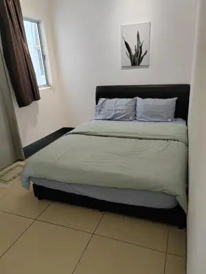 a bedroom with a bed with a plant on it at Golden hill somersqaure 3 bed room islam apartment in Tanah Rata