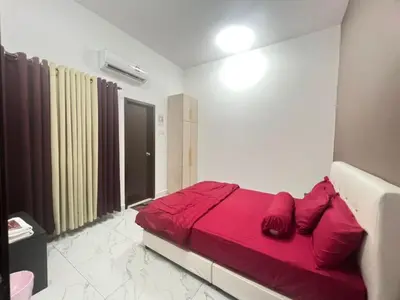 a bedroom with a red bed in a room at Sbb Star Resources Homestay in Sungai Petani