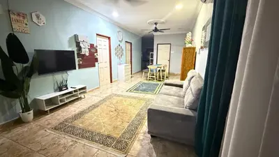 a living room with a couch and a flat screen tv at Mk homestay butterworth in Butterworth