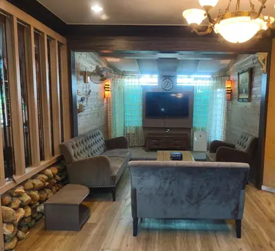 a living room with a couch and a tv at Untaian Kaseh Villa at Tambun by S&S Groups Consultant in Ipoh