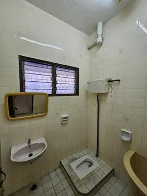 a bathroom with a sink and a toilet at EasyStay Hostel in Ipoh