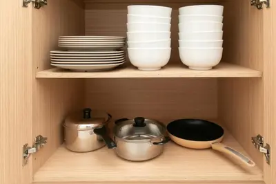 a cupboard with plates and bowls and utensils at Meritus Residensi Seaview Pent Hauz 3BR 10Pax in Perai
