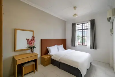 a hotel room with a bed and a mirror at 3-Bedroom Stay at Macalister Road & Georgetown, Noble Villa Penang in George Town