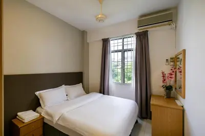 a bedroom with a white bed and a window at 3-Bedroom Stay at Macalister Road & Georgetown, Noble Villa Penang in George Town