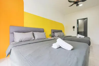 two beds sitting next to each other in a room at Brinchang Cameron Highland Nest Cool Weather & Cozy 10 Pax Clover Home 8-23A in Brinchang