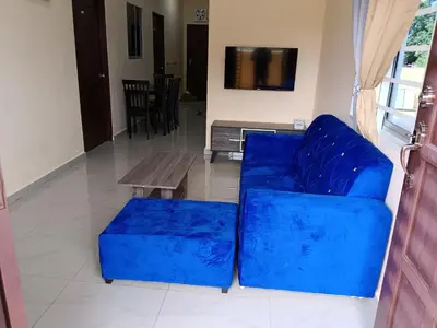 a blue couch and a coffee table in a living room at Rsstay Villa in Lunas