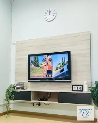 a flat screen tv sitting on top of a entertainment center at Homestay AZ Kulim in Kulim