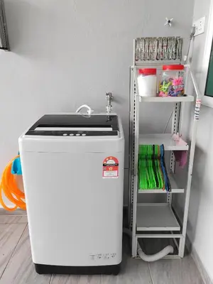 a small refrigerator in a room with a shelf at Ipoh Garden Sunway Guesthouse in Ipoh