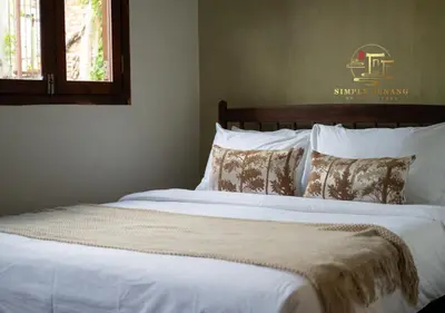 a bedroom with a large bed with white sheets and pillows at Lumut Heritage - a walk to Armenian St Art & Cafes in George Town