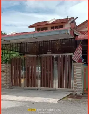 a gate in front of a house with a flag at JJ Homestay Taman Manggis in Balik Pulau