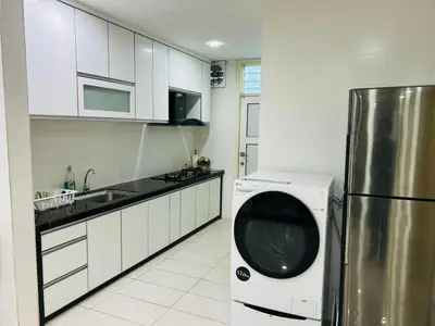a kitchen with a washing machine and a refrigerator at Residensi Seri Pauh in Bukit Mertajam