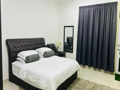 a bedroom with a large bed and a mirror at Residensi Seri Pauh in Bukit Mertajam
