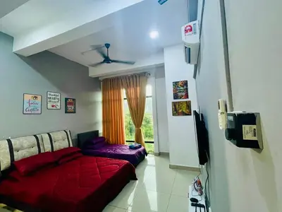 a living room with a red couch and a window at RZHOMESTAy in Gua Musang