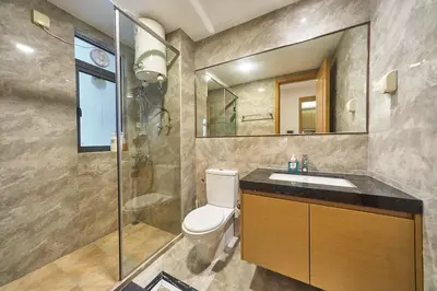 a bathroom with a toilet and a sink and a shower at Princess Cove R&F Luxury apartment with 3 rooms and 2 bathrooms, for 4-6 people, close to the checkpoint, less than 5 minutes away in Gua Sai