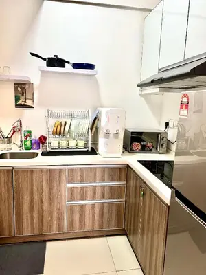 a kitchen with wooden cabinets and a counter top at Ipoh Town Majestic Rena 3R2B 10pax Free 2 carpark in Ipoh