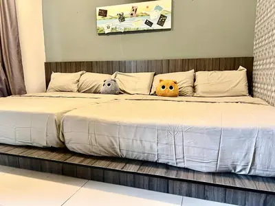 a bed with three stuffed animals sitting on it at Ipoh Town Majestic Rena 3R2B 10pax Free 2 carpark in Ipoh