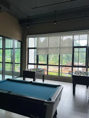 two pool tables in a room with windows at Sunway Onsen Cozy view 4-6pax in Kampong Batu Lapan