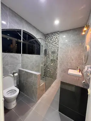 a bathroom with a toilet and a shower and a sink at BungalowD Pool Villa 7R6B with Netflix Great Movies & Dramas in Ipoh