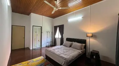 a bedroom with a bed and a ceiling fan at PJ Homestay in Bayan Lepas