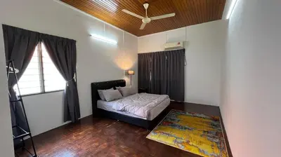 a bedroom with a bed and a ceiling fan at PJ Homestay in Bayan Lepas