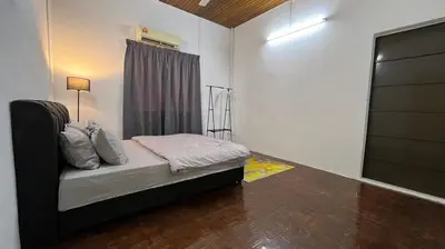 a small bedroom with a bed with a window at PJ Homestay in Bayan Lepas