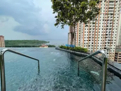 a swimming pool in the middle of a building at Breezy Urban 6pax SeaView InfinityPool Georgetown in George Town