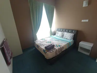 a small bedroom with a bed with a window at DarulMakmur Apartment in Brinchang