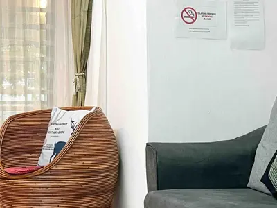 a living room with a chair and a window at \u60a6\u5ba2YK Homestay 5mins to IconCity in Bukit Mertajam